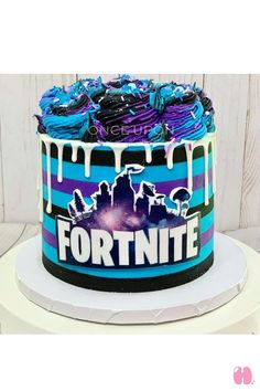 a cake decorated with blue, purple and black icing that says fortnite