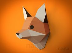 an origami fox head is mounted on the wall with orange walls behind it