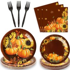 a set of thanksgiving dinnerware with sunflowers and pumpkins on it, along with two forks