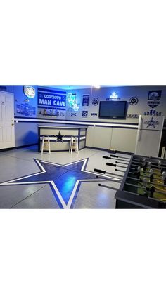 a room filled with foosball tables and soccer goalies