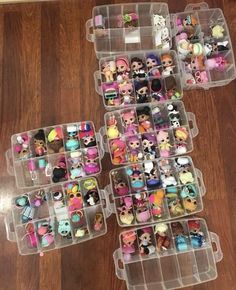 several plastic containers filled with lots of small toy dolls on top of a wooden floor