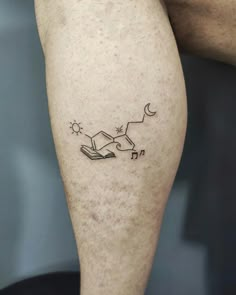 a man with a book tattoo on his leg