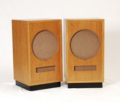 two wooden speakers sitting next to each other