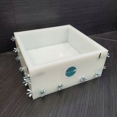 a white box with spikes on the sides