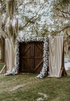 Ceremony doors | wedding ceremony doors | barn doors | wedding ceremony decor | wedding ceremony flowers | wedding ceremony elegant decor | wedding ceremony door entrance | champagne wedding colors | neutral wedding | southern wedding | outdoor ceremony | outdoor ceremony inspo | elegant wedding decor | outdoor wedding | outdoor ceremony decorations | ceremony floral inspo | elegant wedding floral | ceremony flowers | wood doors | wooden doors | barn doors | custom wood doors Outdoor Ceremony Entrance, Wedding Doors Outside, Rustic Wedding Altar Outdoor Ceremony, Wedding Door Entrance Outside, Rustic Door Wedding Entrance, Wedding Ceremony Seating Decor, Door Arch Wedding, Wooden Wedding Doors, Wedding Outdoor Doors