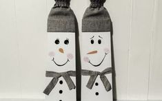 two snowmen made out of socks sitting on top of a white table next to each other