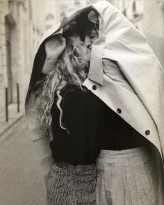 black and white photograph of two people embracing each other on the street in paris, france