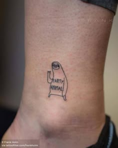 a small tattoo on the ankle of a woman's leg that says party animal