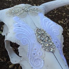 a white cow skull with horns decorated with jewels