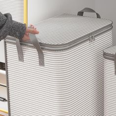 a person is holding onto two suitcases in front of a mirror with yellow handles