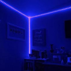 the room is lit up with blue lights and pictures on the wall, along with bookshelves