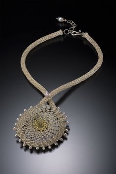 Gold, Silver & Pearl Necklace - Offering a modern take on classic lace, this intricately crafted medallion necklace is composed of wonderfully tactile, twisted sterling silver wire, with bright, smooth sterling silver wire, and luminous 18k gold wire.<br><br>Lustrous akoya pearls dance around the edge of the pendant, and the handwoven chain crisscrosses and flows along the back of the piece. Adjustable length with hook clasp. Elegant Spiral Filigree Jewelry, Gold Necklaces With Sterling Silver Clasp, Wire Knitting, Silver Pearl Necklace, Artful Home, Lucerne, Medallion Necklace, Akoya Pearls, Hook Clasp