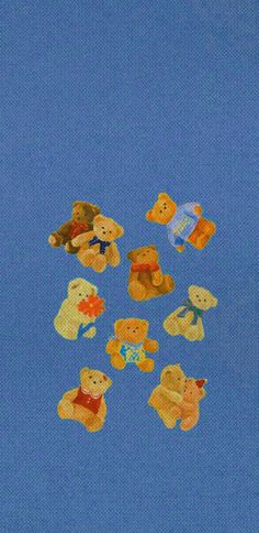 a group of teddy bears sitting on top of a blue surface