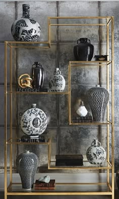 a shelf with vases and other decorative items on it