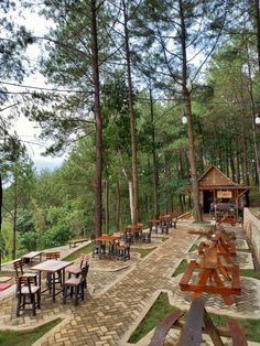 an outdoor picnic area with tables and benches