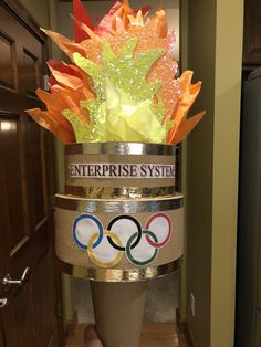 the olympic rings are stacked on top of each other with flowers in them for decoration