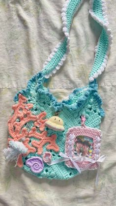 a crocheted purse is laying on a bed