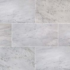 white marble tiles are arranged in four different rows, each with gray veining on the edges