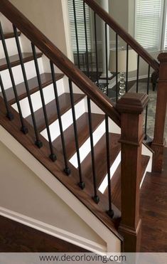 a stair case in a house with wood flooring and white walls, along with hardwood floors