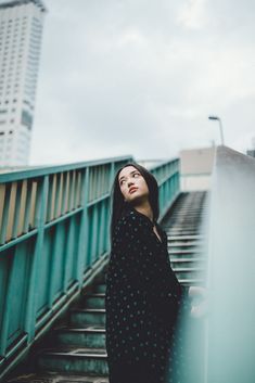 a woman standing on top of a set of stairs