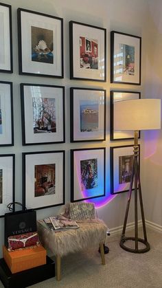 a living room with pictures on the wall and a floor lamp in front of it