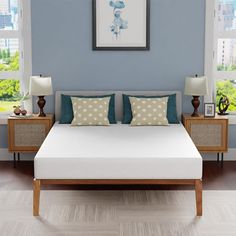 a bed with blue and white pillows in a room