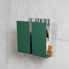 a magazine rack mounted to the side of a wall