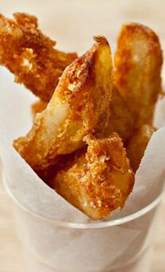 some fried food in a white cup on a table