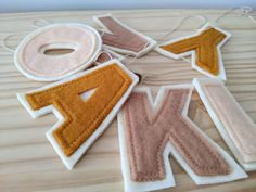 the letter k is made out of felt and has an applique on it