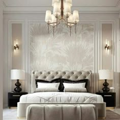 a bedroom with a large bed and chandelier