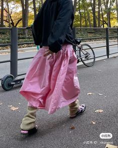 a man walking down the street in pink pants