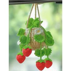 a crocheted hanging basket with strawberries on it