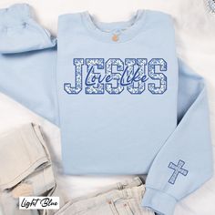 Stay warm and stylish with our cozy sweatshirt! It has "Love Like Jesus" written on the front in a beautiful blue and white French toile pattern. Plus, there's a matching cross on the sleeve. This sweatshirt is perfect for anyone who loves Jesus and wants to share in a fun way. It makes a great gift for friends, family, or even yourself! Ideal for birthdays, holidays, or just because. Wear it to church, while hanging out, or when you're relaxing at home. You'll feel comfy and look great! ♥ ♥ ♥ Thank you for stopping by ♥ ♥ ♥ 👉How to Purchase: ~ Please check and review all photos in the listing. ~ Select what you would like in the drop-down menu. ~ Choose your quantity - as much as you would like! ~ Click add to cart. ~ Click proceed to checkout. ~ Add optional custom requests in the notes Jesus Hoodies, Church Clothes, Christian Streetwear, Jesus Sweatshirts, Toile Pattern, Love Like Jesus, French Toile, White French, Church Outfits