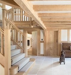 an open floor plan with stairs leading up to the second floor and another room in the background