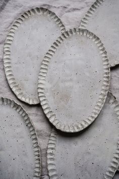 three white plates sitting on top of a table