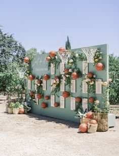 an outdoor basketball court decorated with flowers and paper balls for the wedding guests to sign