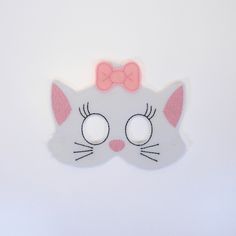 a close up of a cat mask on a white surface