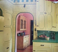 a kitchen with yellow cabinets and green counter tops, painted in pastel pinks