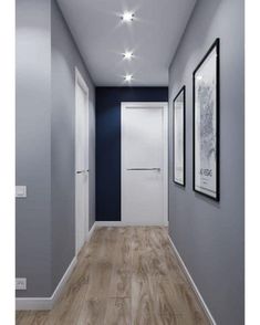 an empty hallway with blue walls and white trim on the doors, wood flooring