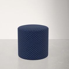 a blue stool sitting on top of a white counter next to a wall and floor