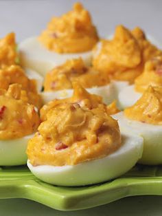 deviled eggs are arranged on a green plate