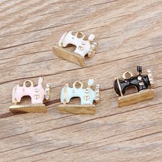 four different types of sewing machine charms