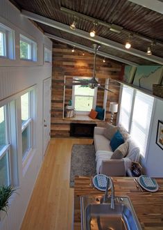 the interior of a tiny home with wood paneling on the walls and ceiling, as seen from above