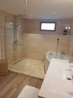 a bathroom with a tub, sink and shower stall in it's own area