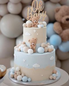 there is a baby cake with teddy bears on it and balloons in the air behind it