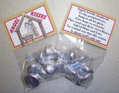 there are some candy wrapped in plastic and on the table next to it is a card that says kiss me kisses