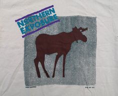 Killer shirt, appears unworn. Very crisp piece.  No rips, holes or stains.  The shirt has little specks of brown in it, like a triblend effect. Very cool.  Medium on tag but measurements below:  P2P = 19" T2B = 29" Alaska Moose, Maltese Archive Shirt, Northern Exposure, Television Show, Alaska, Porter, Gender Neutral, Bathing Beauties, Tops & Tees