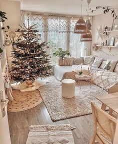 a living room filled with furniture and a christmas tree in the middle of the room