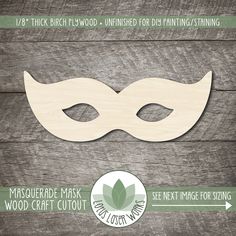 wooden mask cutout with green leaves on top and white text below it that says,