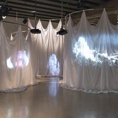 an art installation with white drapes covering the walls